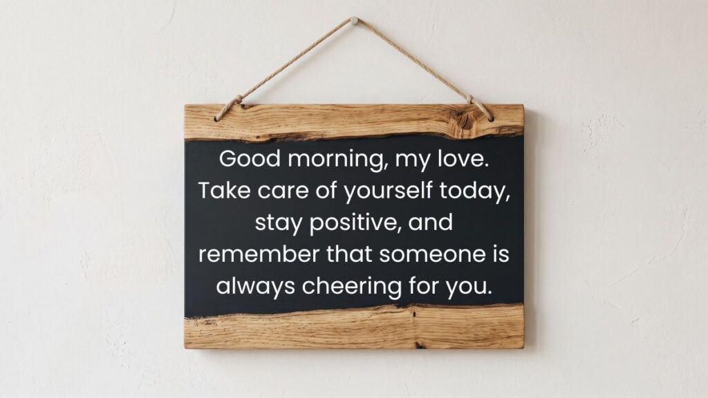 Wooden chalkboard sign hanging on a white wall showing the best morning quotes for him.