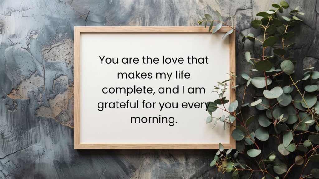 Wooden frame near eucalyptus leaves containing a thoughtful good morning message for my wife on grey background.