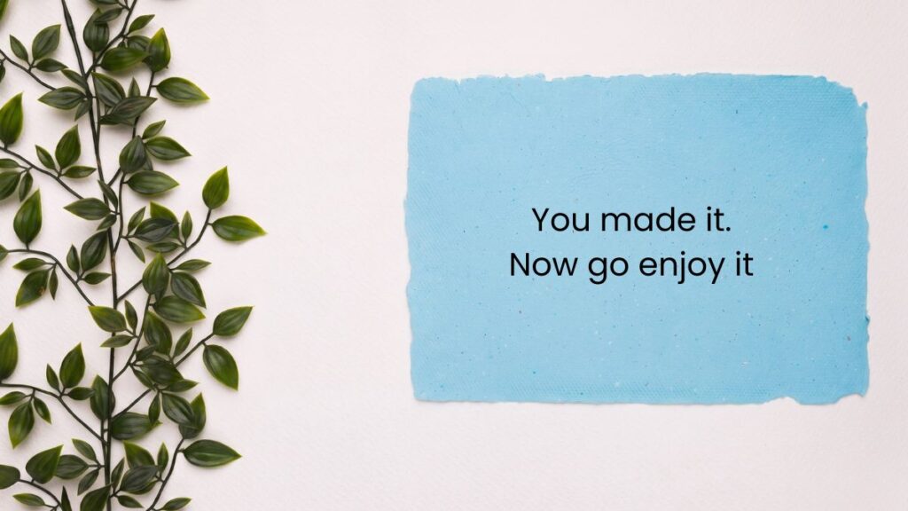 Light blue paper card beside green leafy vine displaying happy friday motivational quotes.
