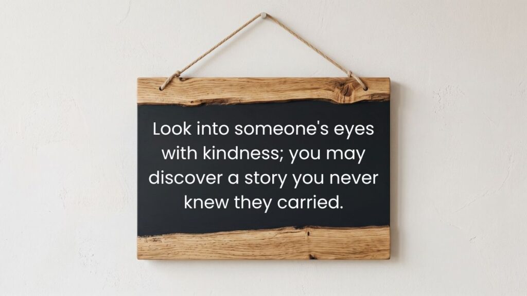 Wooden chalkboard hanging on wall displaying a thoughtful quotation on eyes and discovering hidden stories.