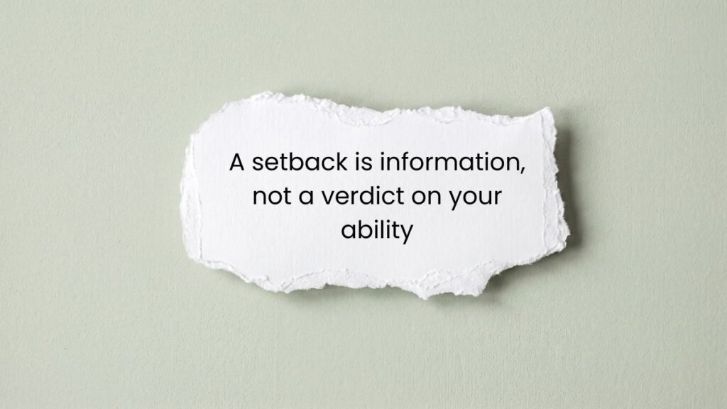 Torn paper note on green surface featuring tuesday motivational quotes for work inspiration.